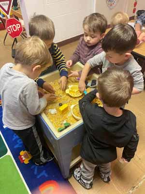 Preschool kids playing in sensory bin